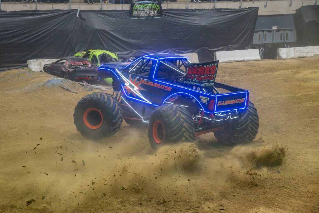 Illuminator Monster Truck performing a dirt-slinging donut during the freestyle competition